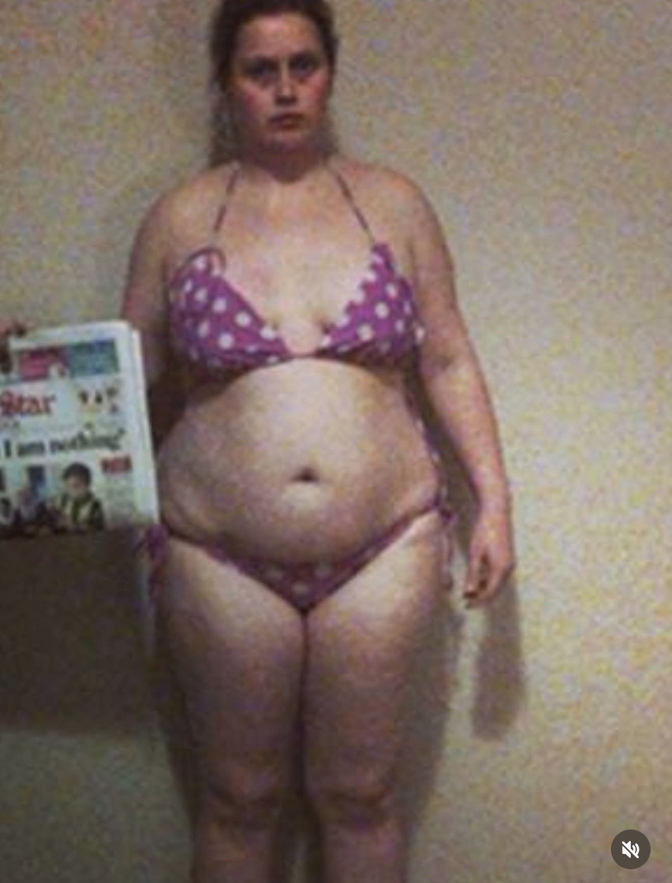 Earlier photo of Gen in a purple polka-dot bikini, holding a newspaper