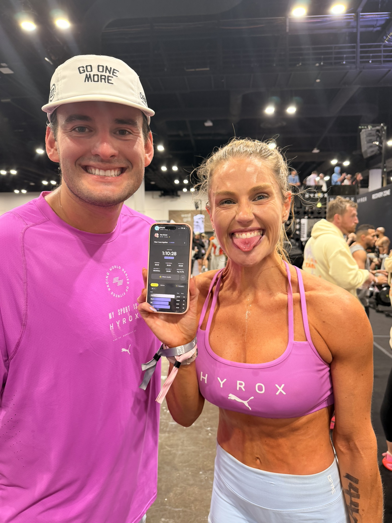 Gen celebrating a Hyrox finish time of 1:10:28 with her partner